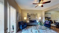 Located at 831 Cedar Lake Rd in Biloxi, Mississippi, this single-story home offers a thoughtfully designed layout that balances comfort and functionality. The living room serves as the heart of the home, featuring warm neutral walls, rich hardwood flooring, a ceiling fan, and an arrangement of gold-framed decorative mirrors that add depth and elegance to the space. An open sightline connects the living area to a dedicated dining space, promoting a seamless flow throughout. The kitchen is outfitted with dark wood cabinetry, crisp white countertops, a double stainless steel sink, and stainless steel appliances, offering both style and practicality. The bedrooms provide comfortable retreats, each with plush carpeting, ceiling fans, and ample natural light streaming through large windows. Generous closet space is featured in the bedrooms, adding to the home's storage capacity. The bathrooms are well-appointed with modern vanities, updated lighting, and a full tub-shower combination. A dedicated laundry room with a full-size washer and dryer and overhead shelving adds everyday convenience. Throughout the home, consistent warm-toned walls and hardwood-style flooring create a cohesive, inviting ambiance.