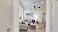 Located in Seabrook, TX, this single-story, 3-bedroom, 2-bathroom home offers a bright and welcoming coastal-inspired atmosphere. The living room is a standout space, featuring soaring vaulted ceilings, a ceiling fan, recessed lighting, and large windows that flood the area with natural light. Wood-look flooring flows throughout the main living areas, complementing the home's clean, neutral color palette.

The open-concept layout connects the living room seamlessly to the combined dining room and kitchen. The kitchen is well-equipped with rich dark cabinetry, granite countertops, a classic white subway tile backsplash, under-cabinet lighting, and ample storage. A built-in desk area adds a functional workspace within the kitchen.

The primary bedroom is a comfortable retreat, complete with plush carpeting, a ceiling fan, and access to a walk-in closet. Two additional bedrooms provide flexible space for guests or other needs. The bathrooms are finished with marble-look tile, including a soaking tub and shower combination in the secondary bath with elegant wall tile surrounds and dark wood cabinetry. A dedicated laundry room and multiple closets round out the practical amenities of this well-designed home.