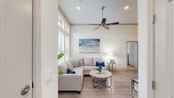 Located in Seabrook, TX, this single-story, 3-bedroom, 2-bathroom home offers a bright and welcoming coastal-inspired atmosphere. The living room is a standout space, featuring soaring vaulted ceilings, a ceiling fan, recessed lighting, and large windows that flood the area with natural light. Wood-look flooring flows throughout the main living areas, complementing the home's clean, neutral color palette.

The open-concept layout connects the living room seamlessly to the combined dining room and kitchen. The kitchen is well-equipped with rich dark cabinetry, granite countertops, a classic white subway tile backsplash, under-cabinet lighting, and ample storage. A built-in desk area adds a functional workspace within the kitchen.

The primary bedroom is a comfortable retreat, complete with plush carpeting, a ceiling fan, and access to a walk-in closet. Two additional bedrooms provide flexible space for guests or other needs. The bathrooms are finished with marble-look tile, including a soaking tub and shower combination in the secondary bath with elegant wall tile surrounds and dark wood cabinetry. A dedicated laundry room and multiple closets round out the practical amenities of this well-designed home.