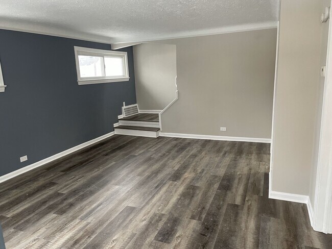 Spacious living room adjacent to kitchen with new plank flooring throughout - 30132 Robert St