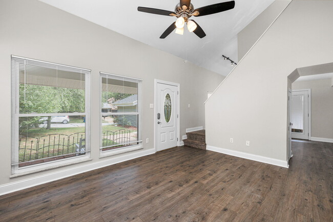 Living room looking back to front door and stairs - 425 Great Hill Dr