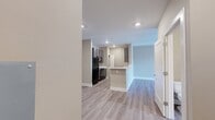 Located at 2712 Country Club Dr in Tallahassee, FL, this one-bedroom, one-bathroom unit offers a thoughtfully arranged single-floor layout. The open-concept kitchen and living area form the heart of the space, featuring light wood-style flooring, recessed lighting, and a neutral warm-beige color palette throughout. The kitchen is equipped with dark cabinetry accented by brushed nickel hardware, crisp white quartz countertops, a peninsula with a breakfast bar, and black stainless appliances. Ample counter space and cabinetry provide excellent storage and functionality.

The living area is bright and airy, benefiting from natural light streaming through large windows and French doors that open to a balcony, complemented by a ceiling fan overhead. The bedroom is a comfortable, well-proportioned retreat with plush carpeting, two windows offering natural light and outdoor views, and its own ceiling fan. A dedicated closet provides convenient storage. The full bathroom features a clean, white tub-shower combination with light wood-style flooring. An in-unit laundry area with washer and dryer hookups adds everyday convenience, rounding out this practical and modern living space.