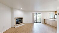 Located at 11400 College Blvd in Overland Park, KS, this thoughtfully designed one-bedroom, two-bathroom residence offers a comfortable and modern living experience across a single floor. Warm hardwood-style flooring flows throughout the main living spaces, complementing the clean white walls and bright, open atmosphere.

The open-concept layout seamlessly connects the living room to the kitchen, which is a clear highlight of the home. The kitchen features sleek, light wood cabinetry, crisp white countertops, a large peninsula with an integrated sink, and a full suite of stainless steel appliances including a refrigerator, electric range, microwave, and dishwasher. A window above the counter invites natural light into the space. In-unit laundry is also conveniently accessible.

The bedroom is a well-proportioned retreat with a window offering views of lush greenery outside, a wall-mounted HVAC unit, and ample room for furnishings. A dedicated closet provides practical storage.

Both bathrooms are finished with light tile flooring, white cabinetry, granite-accented countertops, large vanity mirrors, and a full soaking tub with shower. The bright, neutral palette throughout creates a clean and welcoming ambiance ideal for comfortable everyday living.