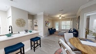 Located at Legacy Oaks Circle in Roswell, GA, this thoughtfully designed single-floor residence offers 2 bedrooms and 2 bathrooms across a comfortable, functional layout. The open-concept living and dining area is bright and welcoming, featuring crown molding, light wood-style flooring, a ceiling fan, and large windows that invite natural light and views of the outdoors. The kitchen is a standout, outfitted with crisp white cabinetry, a classic subway tile backsplash, quartz countertops, a peninsula with an undermount sink, and stainless steel appliances — including a dishwasher and range — all beneath a skylight that adds extra brightness. The spacious primary bedroom provides a relaxing retreat with ample room, neutral tones, and natural light. The second bedroom is equally comfortable, featuring wood-style flooring and a large window. Both bathrooms are clean and functional, with one offering a full tub-shower combination. A dedicated in-unit laundry area houses a full-size washer and dryer. A hallway, closet, and additional storage round out the practical layout. The overall ambiance is warm, modern, and move-in ready.