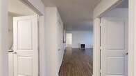 Located at 3407 Brownstone Ct in Post Falls, Idaho, this single-floor, 2-bedroom, 2-bathroom home offers a practical and comfortable layout. The interior opens into a hallway lined with white panel doors, leading to a bright living room featuring dark hardwood-style flooring, a ceiling fan with light fixture, a large window with natural light, and a charming electric fireplace that serves as a focal point of the space. The U-shaped kitchen is well-appointed with white cabinetry, dark countertops, a stainless steel sink, and white appliances including a range with over-the-range microwave. The bedrooms are carpeted for warmth and comfort; the primary bedroom includes generous closet space, while a separate walk-in closet provides ample wire-rack shelving for storage. The bathrooms are clean and functional, with one featuring a full tub/shower combo and a vanity with dark countertop. Additional highlights include a textured ceiling in select rooms, baseboard heating, and an attached single-car garage with a roll-up door and concrete floor. The overall aesthetic is clean and neutral, making this home move-in ready.