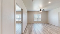 Located at 609 Lupo Lane in Douglas, Georgia, this single-story 2-bedroom, 2-bathroom home offers a well-designed layout with a clean, modern aesthetic throughout. Light wood-look flooring flows seamlessly across the entire home, creating a bright and cohesive feel in every room.

The open living, dining, and kitchen area serves as the heart of the home. The kitchen is thoughtfully appointed with gray shaker-style cabinetry, granite-look countertops, stainless steel appliances including a range, microwave, and refrigerator, and a single-basin sink. A dedicated pantry with wire shelving provides generous storage directly off the kitchen.

The spacious primary bedroom features vaulted ceilings, a ceiling fan with light kit, large windows that allow ample natural light, and a walk-in closet with wire shelving. The second bedroom is equally well-lit, with its own ceiling fan and a wall-mounted mini-split unit for individual climate control.

Both bathrooms mirror each other in design, each featuring dark espresso vanities with granite-look countertops, a tub/shower combination with built-in shelving, and the same wood-look flooring that carries throughout the home. Additional storage is provided by two closets. The overall ambiance is fresh, neutral, and move-in ready.