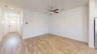 Located at 4300 Longleaf Ln in Union City, GA, this well-designed two-story home offers four bedrooms and three bathrooms across two thoughtfully laid-out floors. Light-toned wood-look flooring runs throughout, creating a cohesive and clean aesthetic from room to room.

The main floor centers around an open-concept kitchen and living area bathed in natural light from large windows with white blinds. The kitchen is a standout feature, boasting a two-tone design with crisp white upper cabinetry and gray lower cabinetry, quartz countertops, a center island with a sink, and a full suite of stainless steel appliances. The adjacent living room is bright and open, featuring ceiling fans and a staircase leading to the upper level.

The upper floor houses the bedrooms, including a comfortable primary bedroom with a ceiling fan and windows that bring in natural light. A dedicated primary bathroom includes a glass-enclosed shower, gray vanity cabinetry, and wood-look tile flooring. Additional bathrooms follow a consistent design language with gray cabinetry, bright vanity lighting, and clean white finishes.

Secondary bedrooms are well-proportioned and well-lit, with the hallway featuring ample space. Throughout the home, a neutral white palette, modern fixtures, and abundant natural light create a bright, welcoming atmosphere suited for everyday living.