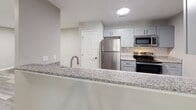 Located at 1523 Roswell Rd in Marietta, GA, this well-appointed 2-bedroom, 2-bathroom residence offers a thoughtfully designed single-floor layout. The open kitchen is a standout feature, showcasing granite countertops, gray shaker-style cabinetry, a subway tile backsplash, and a full suite of stainless steel appliances including a refrigerator, range, and microwave. A peninsula with an integrated sink and breakfast bar connects the kitchen to the main living area, which features durable wood-look flooring throughout.

Both bedrooms are carpeted and feature ceiling fans with light fixtures, neutral-toned walls, and windows that bring in natural light with views of surrounding greenery. Each bedroom is accompanied by a dedicated closet fitted with wire shelving systems for organized storage. The primary bedroom is generously sized and connects to its own closet space.

The two bathrooms are finished with wood-look flooring and clean, contemporary fixtures. One bathroom includes a tub-shower combo with full white subway tile surround and a built-in niche, while the second features accessibility-friendly grab bars. A connecting hallway ties the layout together efficiently, creating a functional and comfortable living environment.