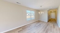 This contemporary residence in Hazel Green, AL offers 1610 square feet of living space across two floors. The ground floor spans 1030 sq ft, while the upper level provides an additional 580 sq ft. The home boasts five bedrooms, including a generous 190 sq ft primary suite, and four bathrooms for ultimate convenience.

The interior showcases modern design elements throughout. Light-toned wood-look flooring runs seamlessly across all rooms, creating a cohesive and airy atmosphere. The walls are painted in neutral hues, providing a blank canvas for personalization. Recessed lighting and stylish fixtures illuminate the space effectively.

The heart of the home is the open-concept kitchen and living area. The kitchen features crisp white cabinetry, stainless steel appliances, and an expansive granite-topped island, perfect for casual dining and entertaining. Large windows in the living spaces and bedrooms flood the rooms with natural light and offer views of the surrounding area.

The bathrooms are outfitted with contemporary fixtures, including pedestal sinks and granite countertops. Ample storage is provided by walk-in closets with wire shelving systems. For added convenience, the home includes an attached garage with a modern automatic door system.

Overall, this residence offers a harmonious blend of style, comfort, and functionality, ideal for modern family living.
