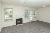 Located at 3145 Lohr Rd in Ann Arbor, MI, this three-floor home offers a well-distributed layout across its main level, upper floor, and basement. The main living area features plush carpeting, a textured ceiling, and a fireplace framed by multiple windows and a glass-paned exterior door that invites abundant natural light and outdoor views of surrounding greenery. The kitchen is equipped with warm oak cabinetry, ample counter space, and a gas range with overhead ventilation, providing a functional cooking environment. Carpeted bedrooms are found on the upper level, where vaulted ceilings lend a sense of openness. The home includes multiple bathrooms outfitted with wood-look flooring, white vanities with mirrored medicine cabinets, and a full tub-shower combination. A half bath with a single vanity is also present. The unfinished basement offers generous open space with exposed wood-beam ceilings, visible ductwork, and concrete flooring, presenting versatile potential for storage or future development. An attached single-car garage with an automatic door opener completes the home, adding practical convenience to this multi-level Ann Arbor residence.