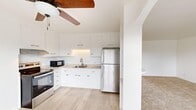 Located at 232 Winding Way in Napa, CA, this three-bedroom, one-bathroom residence offers a clean and functional layout across a single primary floor. The kitchen is a standout feature, showcasing crisp white cabinetry, light wood-style flooring, stainless steel appliances including a refrigerator and range, an under-cabinet microwave, and a single-basin sink — all complemented by a ceiling fan that enhances airflow throughout the open area. The kitchen flows naturally into the adjoining living room, which is carpeted in warm neutral tones and benefits from natural light.

Each of the three bedrooms is finished with soft carpet, ceiling fans, and white walls that create a bright, airy atmosphere. The primary bedroom includes a walk-in closet with built-in shelving, while additional bedrooms offer comfortable proportions and natural light through windows with vertical blinds. The shared bathroom is well-appointed with marble-style tile flooring and wall surround, a glass-enclosed walk-in shower, a white vanity with ample storage, and brushed gold hardware accents.

A private balcony provides outdoor access and overlooks a landscaped community setting with mature trees and greenery — a peaceful retreat in the heart of Napa Valley.