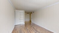 Located at 2800 W T C Jester Blvd in Houston, TX, this single-floor, 2-bedroom, 1-bathroom unit offers a practical and comfortable layout. Throughout the living areas and bedrooms, warm wood-look laminate flooring creates a cohesive and inviting atmosphere, complemented by neutral toned walls and clean white trim and baseboards.

The primary bedroom is a generously sized retreat, featuring a ceiling fan, built-in open shelving, and a closet for convenient storage. The second bedroom is equally comfortable, boasting a ceiling fan and a window that invites natural light and views of the surrounding greenery. Additional closet space is found throughout the unit, ensuring ample storage options.

The kitchen is efficiently designed with a galley-style layout, offering white cabinetry, dark granite-style countertops, a double-basin sink, and white appliances, including a refrigerator, stove, and dishwasher. The marble-look tile flooring adds a clean, polished touch to the space.

The bathroom is a standout feature, showcasing large-format marble-look wall tiles surrounding a full soaking tub with a shower, paired with matching floor tiles and a dark granite-top vanity. A hallway connects the rooms, creating a smooth and functional flow throughout this well-appointed Houston residence.