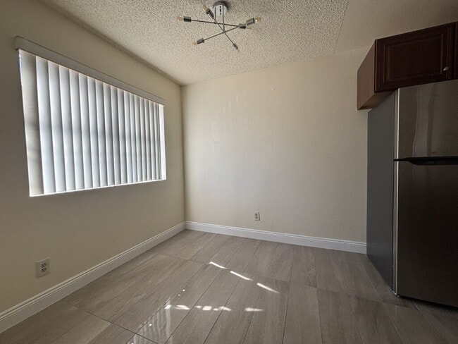 Building Photo - Downstairs 2BR/1BA—recently updated with new flooring, new countertops, and clean, neutral finishes.