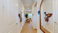 Located at 200 Villas Dr in Lavon, TX, this single-story 2-bedroom, 3-bathroom home offers a thoughtfully designed layout that maximizes every inch of its intimate floor plan. Light wood-look flooring flows seamlessly throughout, creating a cohesive and airy feel from entry to bedroom.

The welcoming entryway hallway leads past closets and access points to the rest of the home, opening into a comfortable living room filled with natural light from a large window with blinds. A ceiling fan, gallery wall arrangement, and warm neutral tones make this space inviting and functional.

The kitchen is a standout feature, equipped with crisp white shaker cabinetry, a white subway tile backsplash, stainless steel appliances including a refrigerator, range, microwave, and dishwasher, and a central island with seating — ideal for casual dining. Pendant lighting adds a modern touch.

Both bedrooms are well-proportioned, each with ceiling fans, wood-look flooring, and natural light from windows with blinds. The primary bedroom connects to a dedicated bathroom featuring a glass-enclosed shower, a white vanity with ample counter space, and direct access to a walk-in closet. A secondary bathroom serves the additional bedroom with equal attention to clean, modern finishes. A dedicated laundry area and additional closets round out this efficient and stylish home.