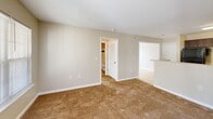 Located at 104 Sharon Ct in Blaine, Tennessee, this single-story, 2-bedroom, 2-bathroom home offers a practical and well-organized layout. The open kitchen and living area serves as the heart of the home, featuring a peninsula with light countertops that provides a natural divide between the two spaces. The kitchen is equipped with dark espresso cabinetry, ample upper and lower storage, light countertops, and a black electric range with overhead ventilation. Warm-toned tile flooring carries through the kitchen and dining areas, while plush carpeting extends through the living room and bedrooms, adding comfort underfoot. The living room benefits from multiple windows and a glass-paneled exterior door that invites natural light and outdoor views. The spacious primary bedroom includes a ceiling fan, a window with natural light, and direct access to a private bathroom and closet. The second bedroom features a double-door closet and its own window. Both bathrooms are finished with warm stone-toned floor tiles and tub-shower combinations accented by white tile surrounds with a rich burgundy tile border detail. A hallway connects the bedrooms and bathrooms, completing this efficiently designed single-floor home.