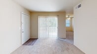 Located on Greenlawn Drive in Columbia, South Carolina, this single-floor unit offers a functional and straightforward layout designed for comfortable everyday living. The main living area is spacious and carpeted, featuring a sliding glass door dressed with vertical blinds that allows natural light to pour in while providing access to the outdoors. A ceiling fan adds practical comfort to the space, and the entry transitions seamlessly from wood-look flooring into the carpeted living zone.

The kitchen is outfitted with white cabinetry and features granite-style countertops with a bold veining pattern, lending a clean and updated look to the space. Ample counter space on both sides of the kitchen offers plenty of room for meal preparation.

The bedrooms are generously sized, each featuring wall-to-wall carpet, neutral cream-toned walls, and multiple electrical outlets. One bedroom includes a window fitted with horizontal blinds, inviting in views of surrounding greenery. The layout, as shown in the dollhouse view, reveals a well-organized floor plan with clearly defined living, sleeping, and utility zones connected by a central hallway.

The bathroom includes a full-size tub and shower combo with chrome fixtures and a clean white surround. Overall, the unit presents a neutral, move-in-ready palette throughout.