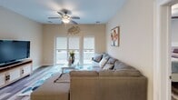 Located at 70 Oak St in Rochelle Park, NJ, this single-floor residence offers three bedrooms and two bathrooms within a thoughtfully designed layout. Wood-look flooring flows consistently throughout the home, complementing the warm neutral tones that define the overall aesthetic.

The living room is a bright, comfortable space featuring a ceiling fan, large windows, and sliding glass doors that open to a private balcony, allowing natural light to fill the room. Adjacent to the living area, the dining space is defined by a pendant light fixture and provides an intimate setting for meals.

The kitchen is well-appointed with gray shaker-style cabinetry, granite countertops, stainless steel appliances including a gas range, microwave, and refrigerator, and a breakfast bar for casual dining.

The primary bedroom is generously sized with a ceiling fan, hardwood-style flooring, and a window that invites natural light. The second and third bedrooms are comfortably proportioned, each with windows and the same cohesive flooring. Both bathrooms feature dark wood vanities with white countertops and wood-look tile flooring. The primary bath includes a large mirror with vanity lighting and open shelving, while the second bathroom maintains a clean, functional design. The residence presents a polished and move-in-ready living experience.