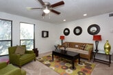 This single-story home on Frankford Avenue in Lubbock, Texas, offers a well-organized layout with distinct living spaces designed for comfort and functionality. The main living area is generously sized, featuring recessed lighting, a textured ceiling, and soft carpet underfoot. A trio of decorative round mirrors anchors the main seating wall, while large windows in the adjoining sitting area flood the space with natural light and offer views of mature outdoor greenery. A ceiling fan adds practicality to both zones.

The kitchen is equipped with warm-toned wood cabinetry offering abundant storage, light countertops, tile flooring, and white appliances including a range and dishwasher — a practical and efficient workspace.

The bedrooms are each uniquely appointed. One features hardwood-style flooring, pendant lighting, and wall-mounted décor panels for a serene atmosphere. Another offers plush carpet, a ceiling fan, a window with natural light, and a built-in shelving unit. A third bedroom includes carpet, a ceiling fan, and a closet with shelving. Each room provides a comfortable, private retreat.

The bathroom is finished with tile flooring, a wood-cabinet vanity, framed mirror, and overhead lighting, keeping the space clean and functional. This home presents a versatile and livable floor plan suited for a variety of lifestyles.