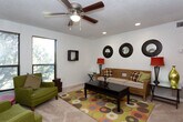 This single-story home on Frankford Avenue in Lubbock, Texas, offers a well-organized layout with distinct living spaces designed for comfort and functionality. The main living area is generously sized, featuring recessed lighting, a textured ceiling, and soft carpet underfoot. A trio of decorative round mirrors anchors the main seating wall, while large windows in the adjoining sitting area flood the space with natural light and offer views of mature outdoor greenery. A ceiling fan adds practicality to both zones.

The kitchen is equipped with warm-toned wood cabinetry offering abundant storage, light countertops, tile flooring, and white appliances including a range and dishwasher — a practical and efficient workspace.

The bedrooms are each uniquely appointed. One features hardwood-style flooring, pendant lighting, and wall-mounted décor panels for a serene atmosphere. Another offers plush carpet, a ceiling fan, a window with natural light, and a built-in shelving unit. A third bedroom includes carpet, a ceiling fan, and a closet with shelving. Each room provides a comfortable, private retreat.

The bathroom is finished with tile flooring, a wood-cabinet vanity, framed mirror, and overhead lighting, keeping the space clean and functional. This home presents a versatile and livable floor plan suited for a variety of lifestyles.