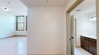 Located at 600 N High Ave in Oklahoma City, OK, this well-appointed 2-bedroom, 3-bathroom residence offers a thoughtfully designed single-floor layout. The kitchen is a functional centerpiece, featuring rich dark wood cabinetry, stainless steel appliances including a refrigerator, dishwasher, and double wall oven, and light countertops — all set against warm hardwood flooring that flows throughout the space. Impressively tall ceilings in the main living and kitchen areas create an open, airy atmosphere that enhances the sense of space.

The primary bedroom is generously sized with soaring ceilings, built-in open shelving and closet space, and access to additional storage. The second bedroom benefits from large, grid-paned windows that invite abundant natural light and offer views of the surrounding neighborhood. A dedicated closet provides additional storage convenience.

All three bathrooms are finished with classic white penny tile flooring and feature dark wood vanities with light countertops. Accessibility-focused grab bars are thoughtfully incorporated, with one bathroom offering a combined tub and shower. The layout is completed by a hallway connecting the key areas of the residence, ensuring a smooth and practical flow throughout.