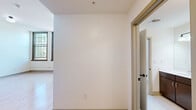 Located at 600 N High Ave in Oklahoma City, OK, this well-appointed 2-bedroom, 3-bathroom residence offers a thoughtfully designed single-floor layout. The kitchen is a functional centerpiece, featuring rich dark wood cabinetry, stainless steel appliances including a refrigerator, dishwasher, and double wall oven, and light countertops — all set against warm hardwood flooring that flows throughout the space. Impressively tall ceilings in the main living and kitchen areas create an open, airy atmosphere that enhances the sense of space.

The primary bedroom is generously sized with soaring ceilings, built-in open shelving and closet space, and access to additional storage. The second bedroom benefits from large, grid-paned windows that invite abundant natural light and offer views of the surrounding neighborhood. A dedicated closet provides additional storage convenience.

All three bathrooms are finished with classic white penny tile flooring and feature dark wood vanities with light countertops. Accessibility-focused grab bars are thoughtfully incorporated, with one bathroom offering a combined tub and shower. The layout is completed by a hallway connecting the key areas of the residence, ensuring a smooth and practical flow throughout.