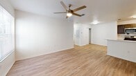 Located at 1589 Star Light Cove in Tarpon Springs, Florida, this single-story, 2-bedroom, 2-bathroom home offers a bright and well-maintained living environment with a consistent, modern aesthetic throughout. Light wood-look flooring runs seamlessly across all rooms, complemented by crisp white walls and clean white baseboards that give the home a fresh, airy feel.

The open kitchen is equipped with stainless steel appliances, including a gas range, over-the-range microwave, and refrigerator. Dark gray shaker-style cabinetry with brushed nickel hardware provides ample storage, while light countertops add contrast. The kitchen connects to the living area, which features a ceiling fan with light and access to the rest of the home.

Both bedrooms are well-proportioned, each with ceiling fans and natural light from windows overlooking the surrounding neighborhood. The primary bedroom is notably spacious and offers direct access to one of the bathrooms. That bathroom features a dark-cabinetry vanity with a white countertop, a wall-mounted mirror, and wood-look flooring. The second bathroom is outfitted with a full tub/shower combo with white tile surround. A dedicated closet adds additional storage. The home's layout is functional and efficient, making excellent use of its footprint.