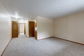 Located at 7319 Wirt Circle in Omaha, Nebraska, this 2-bedroom, 1-bathroom unit offers a straightforward single-floor layout designed for comfortable everyday living. The floor plan flows efficiently, connecting the living area, kitchen, and bedrooms with ease of access throughout.

The spacious primary bedroom is a standout feature, offering generous room for furnishings and is complemented by a large sliding double-door closet with warm wood-toned paneling, providing substantial storage space. A second bedroom features plush carpeting and a window dressed with vertical blinds, allowing natural light to filter into the room. Both bedrooms are finished with neutral cream-toned walls, wood baseboards, and textured ceilings.

The living area is open and airy, with soft carpeting underfoot and neutral walls that provide a clean, versatile backdrop. The kitchen is equipped with wood-toned cabinetry and a white range, offering a compact yet functional cooking space. The bathroom features a shower/tub combination with a stylish patterned curtain, a toilet, and hard surface flooring. Additional features throughout include track lighting, wall sconces, and louvered interior doors that add a classic touch to the overall aesthetic.
