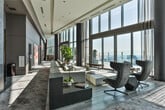 Located at 3390 Stratford Rd NE in Atlanta's Buckhead neighborhood, this high-rise amenity floor offers an exceptional collection of luxury spaces designed for both relaxation and entertainment. Soaring floor-to-ceiling windows flood the expansive main lounge with natural light and frame sweeping panoramic views of the Atlanta skyline and surrounding cityscape. The open-plan lounge features refined seating arrangements, marble-toned flooring, curated indoor greenery, and bold contemporary artwork that lines the gallery-style corridors.

The game room is a sophisticated retreat, appointed with a billiards table, a poker table, built-in cue storage, and plush velvet seating — all set against dramatic double-height windows offering commanding skyline views. An adjacent lounge nook with booth seating and a wall-mounted display provides a casual dining and social space.

The private cinema room delivers an immersive experience, complete with a projection screen, tiered sectional seating, and ornate framed artwork that lends a rich, intimate atmosphere. A dedicated spa suite offers a serene escape, featuring dual massage tables, warm wood finishes, and a glass-enclosed wet room with a soaking tub and rain shower. Throughout, the design balances modern elegance with refined comfort.