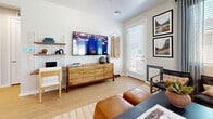 Located in Phoenix, AZ, this thoughtfully designed one-bedroom, one-bathroom home offers a smart, efficient layout spread across a single floor. Light wood flooring flows throughout, lending warmth and continuity to every room.

The open-concept kitchen and living area forms the heart of the home. The kitchen is outfitted with white shaker cabinetry, quartz countertops, stainless steel appliances — including a French door refrigerator, range, microwave, and dishwasher — and a large island with seating, ideal for casual dining or meal prep. Natural light pours in through multiple windows fitted with blinds.

The living room is bright and welcoming, featuring large corner windows with sheer draping that fill the space with daylight. A private door leads directly outside, enhancing the sense of openness.

The bedroom is a calm retreat highlighted by a bold teal accent wall, a ceiling fan, and a sun-filled window. It connects directly to a dedicated walk-in closet with built-in storage and to the full bathroom via a hallway. The bathroom features white cabinetry, a quartz vanity, and a glass-enclosed shower.

A hallway connects the living areas to the private spaces, completing this clean, modern home.
