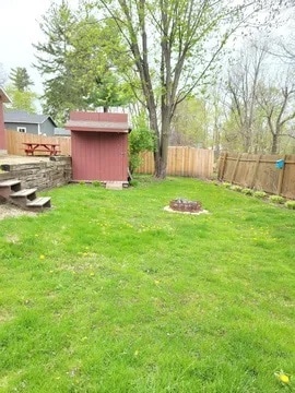 Garden shed and fire pit in back yard. - 438 E 7th St