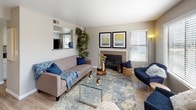 This single-floor residence offers a thoughtfully designed layout that balances comfort and functionality. The living room serves as the heart of the home, featuring a tile-surround fireplace, wood-look flooring, and a pass-through opening to the kitchen. Natural light filters in through multiple windows with blinds, and a sliding glass door provides access to the outdoors. An accent wall with a bold geometric pattern adds visual interest to the adjoining dining area.

The galley-style kitchen is lined with white cabinetry, dark marble-look countertops, and wood-look flooring, offering ample workspace and storage on both sides. A dedicated laundry area houses a full-size side-by-side washer and dryer with overhead shelving for additional storage convenience.

The bedroom is a comfortable retreat with plush carpeting, multiple windows that invite natural light, and a decorative accent wall. It includes two open closets providing generous storage space. The full bathroom features wood-look flooring, a white vanity with storage, and a tub-shower combination, completing this well-rounded residence.