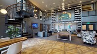 Located at 105 Corporate Park Dr in West Harrison, NY, this two-floor amenity space is designed with a refined, upscale aesthetic that balances sophistication with functionality. The grand main level centers around a dramatic double-height library lounge, where floor-to-ceiling bookshelves line the walls and are accessible via a rolling ladder. Intricate geometric parquet wood flooring flows throughout, complementing the deep gray paneled walls and curated artwork. A marble-topped bar counter provides an elegant gathering spot alongside plush seating areas, a fireplace, and a billiard table. A striking black spiral staircase serves as both a functional and architectural centerpiece, connecting the two levels. A dedicated lounge area features rich crimson velvet chairs, a gold accent table, a chandelier, and a package locker wall. The upper level offers a well-appointed coworking space with carpet flooring, open work tables, glass-partitioned private rooms, and ample natural light from large windows. A bright recreation lounge showcases soaring vaulted ceilings with exposed dark beams, pendant globe lighting, a wall of tall windows with outdoor views, herringbone wood flooring, comfortable sectional seating, and a foosball table — ideal for casual gathering and leisure.