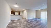 Located at 100 Grenache Blanc Dr in Saint Peters, Missouri, this single-floor residence offers a well-designed, open-concept layout finished with contemporary details throughout. The main living area features durable wood-look plank flooring, recessed lighting, and a ceiling fan, creating a bright and welcoming atmosphere that flows seamlessly into the kitchen and dining space.

The kitchen is a standout feature, outfitted with rich dark cabinetry, granite countertops, stainless steel appliances, a tile backsplash, and a large peninsula with bar seating — ideal for both casual dining and entertaining. An adjacent island provides additional prep space and storage.

The bedrooms are carpeted for comfort, with one featuring a mirrored sliding-door closet and a ceiling fan, while another offers a window with natural light and a neutral color palette. The bathroom is finished with granite countertops, dark wood cabinetry, tile flooring, and a full tub-shower combination with oil-rubbed bronze fixtures.

A dedicated laundry room houses a full-size washer and dryer with overhead wire shelving for added storage convenience. The entry foyer provides a clean transition into the living space, reinforced by consistent warm-toned walls and wood-look flooring that tie the home's aesthetic together cohesively.