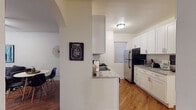 Located in Chicago's prestigious Gold Coast neighborhood, this single-floor unit at 21 W Elm St offers a thoughtfully designed layout with hardwood flooring throughout. The updated kitchen is a standout feature, showcasing white shaker-style cabinetry, granite-look countertops, a subway tile backsplash, and stainless steel appliances including a gas range, dishwasher, and refrigerator. A peninsula counter connects the kitchen to the adjacent dining area, creating an open, functional flow. The combined living and dining area is bright and welcoming, complete with a ceiling fan, ample natural light, and a comfortable, open arrangement well-suited for everyday living and entertaining. The space includes multiple bedrooms, each featuring hardwood floors, windows with natural light, and ceiling fans or pendant lighting. Crown molding in select rooms adds a refined architectural touch. One bedroom includes a closet with built-in shelving. The clean, neutral color palette and modern décor accents lend the space a contemporary yet comfortable ambiance, making this Gold Coast unit a well-rounded and practical home in one of Chicago's most sought-after neighborhoods.