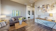 Located at 2121 N Grace Blvd in Chandler, Arizona, this single-story residence offers 2 bedrooms and 3 bathrooms with a thoughtfully designed layout. The open-concept living room is bathed in natural light from large windows dressed with sheer curtains and blinds, and features wood-style flooring and a ceiling fan overhead. The kitchen is well-equipped with dark cabinetry, granite countertops, stainless steel appliances including a range, microwave, dishwasher, and refrigerator, along with a peninsula island with bar seating — ideal for casual dining. Recessed lighting adds a clean, modern touch to the space. The primary bedroom is comfortably sized, featuring wood-style floors, a window with natural light, and easy access to a dedicated closet. The second bedroom is bright and welcoming, with multiple windows allowing ample daylight. Three bathrooms serve the home, including one with a tub/shower combination and natural light from a window. A hallway connects the living areas to the private quarters. The warm, neutral color palette throughout creates a cohesive and inviting ambiance, making this Chandler residence a functional and comfortable home.