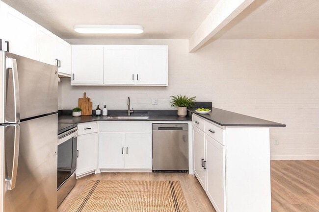 Kitchen with white cabinetry and countertop - Miramonte on 3rd