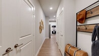 This thoughtfully designed single-floor residence offers a comfortable and functional layout across a well-utilized footprint. A welcoming entry hallway with recessed lighting and light wood-style flooring guides residents through the space, with multiple closets conveniently positioned for storage.

The open-concept kitchen and living area serves as the heart of the home. The kitchen is outfitted with crisp white shaker cabinetry, a classic subway tile backsplash, stainless steel appliances including a gas range, built-in microwave, dishwasher, and refrigerator, along with a sleek marble-topped island ideal for dining or meal prep. The adjoining living room is bright and airy, featuring multiple large windows that flood the space with natural light and offer outdoor views, complemented by a ceiling fan overhead.

The bedroom is a comfortable retreat with its own natural light from dual windows, a ceiling fan, and hardwood-style flooring. It provides direct access to the full bathroom, which includes a shower-tub combination. Three closets throughout the unit ensure generous storage. A dedicated laundry area adds everyday convenience. Neutral tones and clean finishes throughout give the entire residence a modern, cohesive aesthetic.