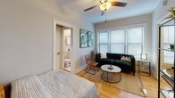 Located in Chicago's vibrant Hyde Park neighborhood, this single-floor unit at 5424 S Cornell Ave offers a well-designed layout with a warm, inviting ambiance throughout. Warm-toned hardwood floors run through the main living areas, lending the space a classic and cohesive character.

The living area is bright and welcoming, featuring large windows with horizontal blinds that allow generous natural light to fill the room. A ceiling fan adds comfort, and the open flow into a dedicated nook with a built-in counter and bar-height seating makes for a practical and versatile dining or workspace.

The bedroom is comfortably sized, with continued hardwood flooring, soft neutral walls, and access to a private bathroom. A round wall mirror, vanity-style side table, and tasteful artwork contribute to its relaxed, functional feel.

The kitchen is equipped with warm wood cabinetry, dark speckled countertops, a stainless steel sink, and ample upper and lower storage. A full-size refrigerator completes the setup.

The bathroom features classic white tile, a bathtub with shower, a window for ventilation, and a traditional cast-iron radiator — a nod to the building's architectural heritage. Overall, the unit combines practical functionality with comfortable, understated style in a prime Chicago location.