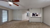 Located in Collierville, TN, this well-appointed 3-bedroom, 2-bathroom single-floor residence combines functional design with thoughtful updates throughout. The open-concept living and dining area features plush carpeting, a ceiling fan, and a welcoming fireplace set against neutral-toned walls, with natural light streaming in through large windows fitted with blinds. A sliding glass door provides direct access to the renovated patio, seamlessly connecting indoor and outdoor living spaces.

The kitchen is accessible via a convenient pass-through counter from the living area and showcases gray shaker-style cabinetry, granite-look countertops, wood-look flooring, and black appliances including a range, over-the-range microwave, and refrigerator. The layout is efficient and well-organized, offering ample storage and prep space.

Each of the three bedrooms is carpeted and equipped with a ceiling fan, generous closet space with built-in shelving, and windows that allow for natural light. The bedrooms are connected by a central hallway that provides clear flow throughout the unit. The bathrooms are finished with gray vanity cabinetry, granite-look countertops, and a tub-shower combination. The textured ceilings and consistent neutral color palette lend a cohesive, move-in-ready feel to the entire space.