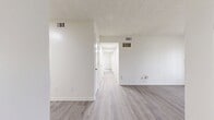 Located at 249 Brookridge Trail in Nashville, TN 37211, this 940-square-foot apartment offers a well-designed single-floor layout with 2 bedrooms, 2 bathrooms, and 3 closets. Throughout the unit, light-toned luxury vinyl plank flooring and neutral cream walls create a cohesive, clean aesthetic.

The combined kitchen and living area serves as the heart of the home. The kitchen features gray shaker-style cabinetry, marble-look countertops, black appliances including a range, dishwasher, and refrigerator, and a skylight that fills the space with natural light. The living room offers a sliding glass door and French doors that invite outdoor views and abundant natural light.

The primary bedroom spans 180 square feet and is equipped with two sets of louvered bi-fold closet doors, providing generous storage. The second bedroom also features a louvered bi-fold closet and a window with natural light. Both bathrooms are finished consistently with gray shaker vanities, marble-look countertops, and full tub-shower combinations with brushed nickel fixtures. Two hallways connect the spaces efficiently throughout the unit, and a textured ceiling is present in select rooms.