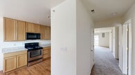 Located at 3525 Rockwood Rd in Newark, Delaware, this single-floor, 2-bedroom, 3-bathroom home offers a well-organized layout with a thoughtful mix of materials and functional design. The living room serves as a central gathering space, highlighted by a corner fireplace and plush carpeting, creating a warm and inviting atmosphere. A pass-through window connects the living area to the kitchen, enhancing the open feel between spaces. The kitchen is outfitted with light wood cabinetry, granite-look countertops, stainless steel appliances including a dishwasher, and a pendant light over a connected dining area with hardwood flooring and a bright window. Both bedrooms feature ceiling fans, soft carpeting, and ample natural light from large windows. The primary bedroom is a comfortable, well-proportioned retreat. Each of the three bathrooms includes a tub-shower combination with clean, white surrounds. Throughout the home, a neutral color palette of whites and beiges creates a bright, cohesive aesthetic. The layout, as seen in the dollhouse view, flows efficiently from the living and kitchen areas to the private bedroom and bathroom spaces, making for a practical and comfortable residence.