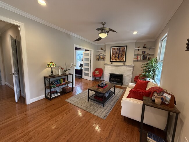 Living room, at the front door. Gas fireplace and lots of light. - 5715 7th St N