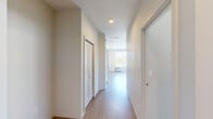 Located in Liberty Lake, WA, this one-bedroom unit offers a thoughtfully laid-out single-level floor plan that maximizes functionality and comfort. The entry hallway sets a clean, neutral tone with light wood-style flooring, a textured ceiling, and recessed lighting that guides you into the main living area. The open-concept living and kitchen space is bright and airy, featuring the same light hardwood-style flooring and track lighting overhead. The kitchen is well-equipped with warm-toned wooden cabinetry extending to the upper walls, a full suite of black appliances including a refrigerator, electric range, dishwasher, and microwave, as well as a functional sink workspace. A large window in the living area fills the space with natural light and provides views of the surrounding community. The bedroom is a comfortable and quiet retreat, finished with plush carpeting and a generously sized window that allows ample daylight to enter while offering views of the outdoor greenery. A closet provides practical storage within the bedroom. Throughout the unit, the neutral color palette, clean lines, and consistent finishes create a cohesive and inviting atmosphere suitable for everyday living.