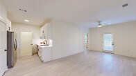 Located in Kathleen, GA, this well-designed 2-bedroom, 2-bathroom home offers a thoughtfully planned single-level layout that maximizes functionality and comfort. Light wood-style flooring flows consistently throughout the space, complementing a bright, neutral color palette that gives every room an airy, modern feel.

The open-concept living area is anchored by a ceiling fan and benefits from multiple windows and a glass-paned exterior door, flooding the space with natural light. The kitchen features white shaker-style cabinetry with black hardware, white quartz countertops, a subway tile backsplash, a matte black undermount sink with a matching faucet, and stainless steel appliances including a refrigerator with ice maker and a range.

Both bedrooms are generously proportioned, each equipped with a ceiling fan and windows with blinds. The primary bedroom offers a comfortable footprint with dedicated closet access. Two full bathrooms mirror each other in design, each offering white vanities with quartz countertops, black hardware accents, tub-shower combinations, and clean tile flooring. A dedicated laundry area and two closets add practical storage. The overall ambiance is clean, contemporary, and move-in ready.
