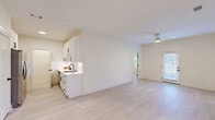 Located in Kathleen, GA, this well-designed 2-bedroom, 2-bathroom home offers a thoughtfully planned single-level layout that maximizes functionality and comfort. Light wood-style flooring flows consistently throughout the space, complementing a bright, neutral color palette that gives every room an airy, modern feel.

The open-concept living area is anchored by a ceiling fan and benefits from multiple windows and a glass-paned exterior door, flooding the space with natural light. The kitchen features white shaker-style cabinetry with black hardware, white quartz countertops, a subway tile backsplash, a matte black undermount sink with a matching faucet, and stainless steel appliances including a refrigerator with ice maker and a range.

Both bedrooms are generously proportioned, each equipped with a ceiling fan and windows with blinds. The primary bedroom offers a comfortable footprint with dedicated closet access. Two full bathrooms mirror each other in design, each offering white vanities with quartz countertops, black hardware accents, tub-shower combinations, and clean tile flooring. A dedicated laundry area and two closets add practical storage. The overall ambiance is clean, contemporary, and move-in ready.