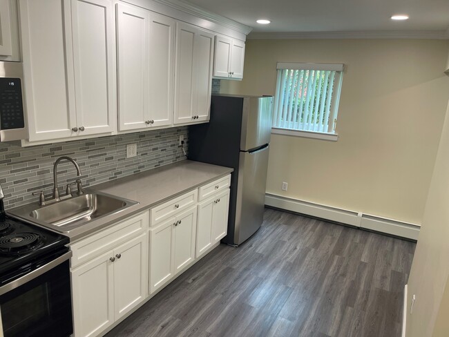 Brand new kitchen with quartz counter top and stainless steel appliances - The Niche at Maple Gardens