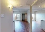 Located at 1319 N. Madison St in Stockton, California, this studio unit offers a well-utilized single-floor layout designed for efficient, comfortable living. The main living area is open and airy, featuring rich hardwood-style flooring that extends throughout the space, providing a warm and cohesive aesthetic. A sliding glass door floods the room with natural light and opens to a private balcony, offering views of the surrounding neighborhood. A built-in closet with a distinctive wood-paneled door provides convenient storage directly within the living area. The compact kitchen is thoughtfully appointed with white cabinetry, a sink, countertop space, and includes a refrigerator and microwave, making it a fully functional cooking space. An overhead HVAC unit ensures year-round climate control. The bathroom is neatly finished with hardwood-style flooring, a white vanity with storage, a wall-mounted mirror, a soaking bathtub with shower, and a toilet — all presented in a clean, neutral palette. A textured ceiling and wall-mounted lighting fixtures complete the interior details. The unit's straightforward layout and practical features make it a functional and accessible living space in central Stockton.