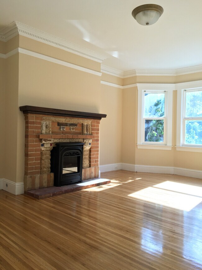Enter into the Bay-windowed living room, with brand-new, remote-controlled gas log fireplace! - 415 Prentiss Street