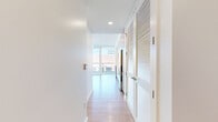 Located on Wilshire Boulevard in the heart of West Los Angeles, this high-rise unit offers a sleek, modern living experience with breathtaking panoramic views of the Los Angeles cityscape and surrounding hills. Light wood flooring flows throughout the open-plan layout, complementing the crisp white walls and clean architectural lines.

The combined kitchen and living area is bathed in natural light, courtesy of expansive floor-to-ceiling windows and direct access to a generous wraparound balcony enclosed by glass railings. The kitchen features contemporary two-tone cabinetry, a subway tile backsplash, and a full suite of stainless steel appliances, including a range, microwave, dishwasher, and refrigerator.

The bedroom is well-proportioned and includes its own floor-to-ceiling window with city views, providing a serene and light-filled retreat. A dedicated closet and hallway offer practical storage solutions. The bathroom is finished in a clean, minimalist style with white subway tile surrounding the bathtub and shower combination, complemented by neutral tile flooring.

The spacious balcony is a standout feature, offering unobstructed elevated views of the Los Angeles skyline, making it an ideal space for enjoying the Southern California climate.