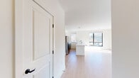 Located at 555 Northfield Avenue in West Orange, NJ, this thoughtfully designed 2-bedroom, 2-bathroom residence offers a bright, modern living experience across a single well-appointed floor. The open-concept kitchen and living area serves as the heart of the home, featuring light hardwood flooring, recessed lighting, and large black-framed windows that flood the space with natural light and offer views of the surrounding neighborhood. The contemporary kitchen is equipped with stainless steel appliances, a gas range, sleek gray cabinetry with modern hardware, and white quartz countertops centered around a convenient island with a sink.

Both bedrooms are generously sized, each benefiting from large windows with outdoor views and the same warm hardwood flooring found throughout. The spacious primary bedroom includes access to multiple closets, providing exceptional storage. A dedicated den adds flexible living space ideal for a home office or additional lounge area. The two bathrooms are finished with striking marble-style tile flooring, floating gray vanities with gold hardware, and elegant marble-tiled showers. Additional highlights include a private balcony, an in-unit laundry area, and an impressive total of seven closets, ensuring ample storage throughout this well-appointed home.